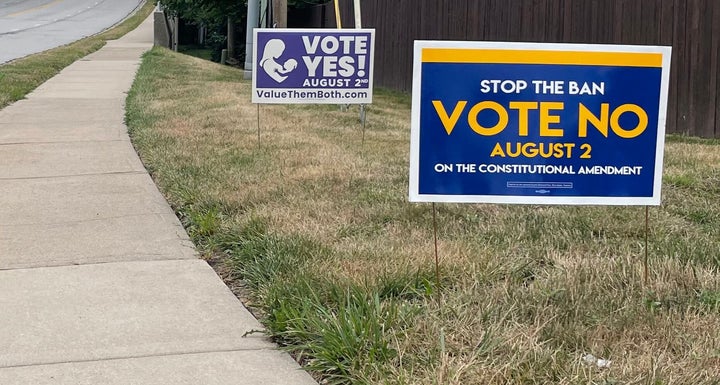 Signs call on voters to vote for or against the Value Them Both amendment in Prairie Village, Kansas, on July 28.