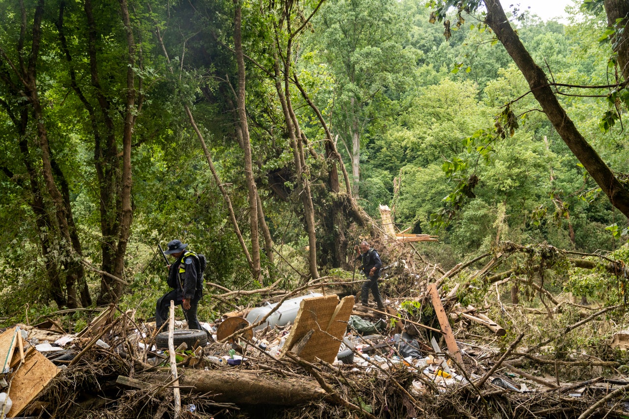 Lexington Fire Department's search and rescue team performs a targeted search on Highway 476 where three people are still unaccounted for near Jackson, Kentucky on July 31. At least 28 people have been killed in the state, with hundreds rescued, but many still unaccounted for due to flooding after heavy rainfall.