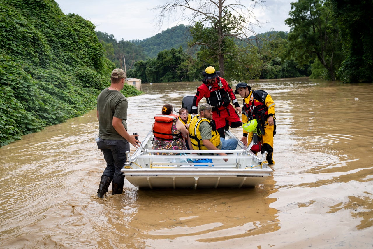 A rescue team from the Jackson Fire Department assists people out of floodwaters downtown Jackson, Kentucky, on July 28. 