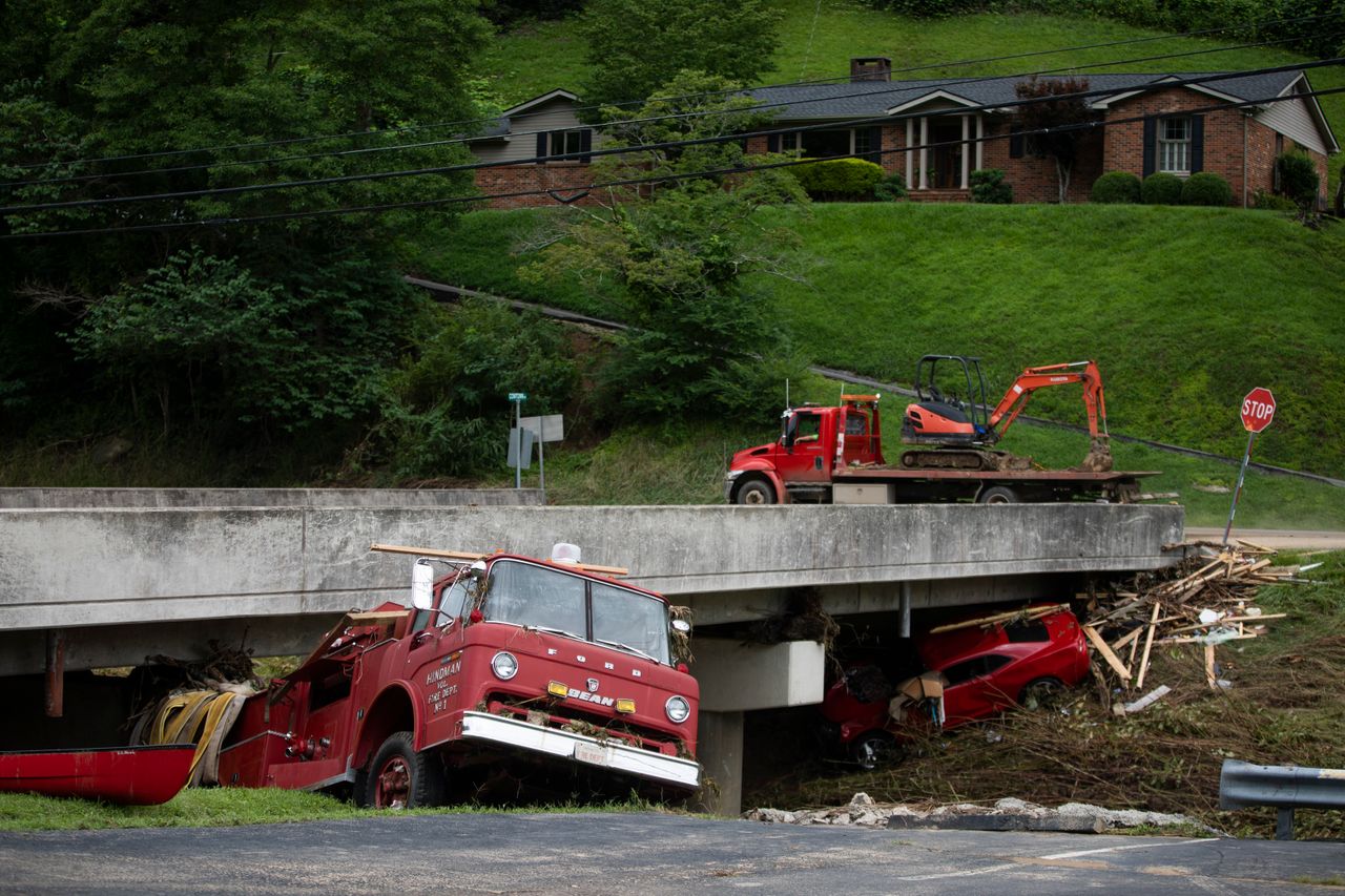 A car and a vintage Hindman Fire Department fire truck remain under a bridge after being washed up by floodwaters in Hindman, Kentucky, on July, 30.