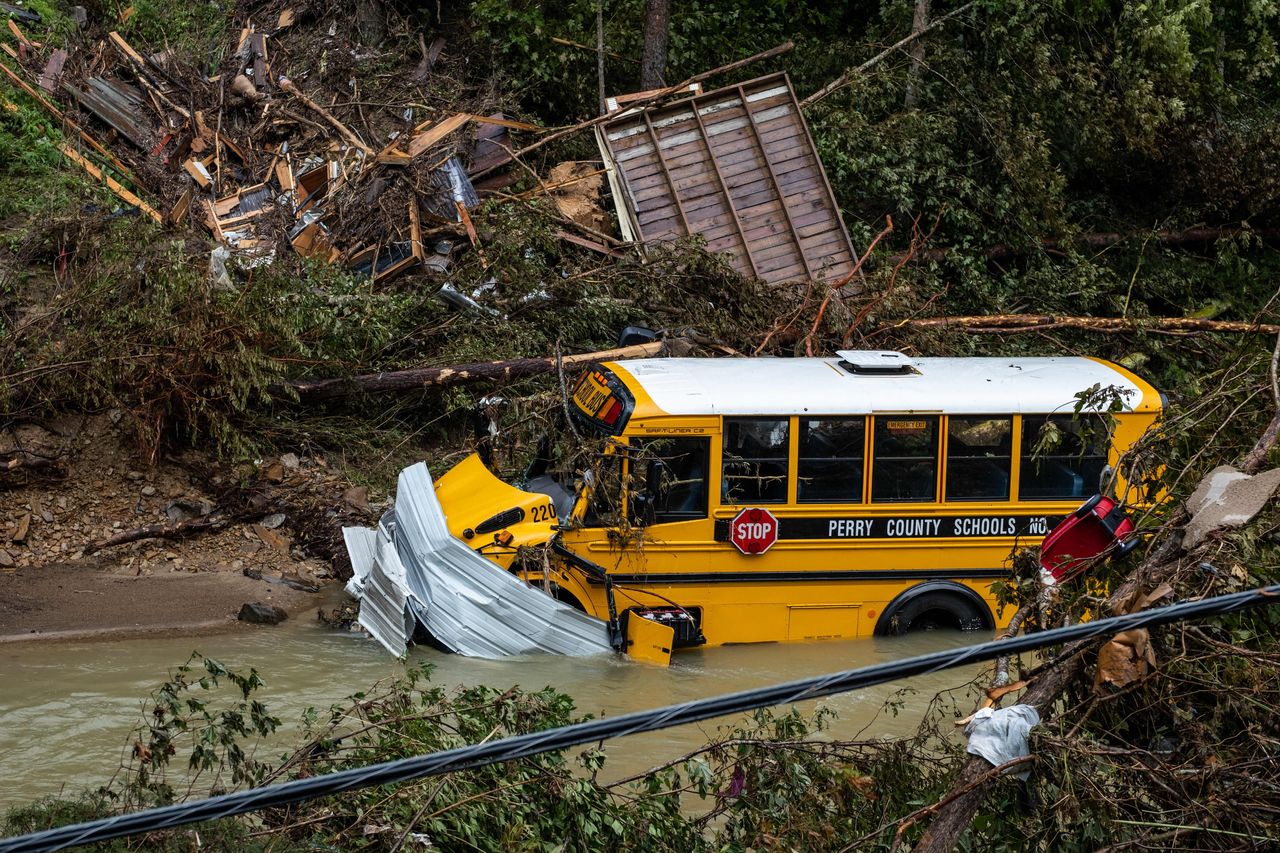 A Perry County school bus, along with other debris, sits in a creek near Jackson, Kentucky, on July 31.