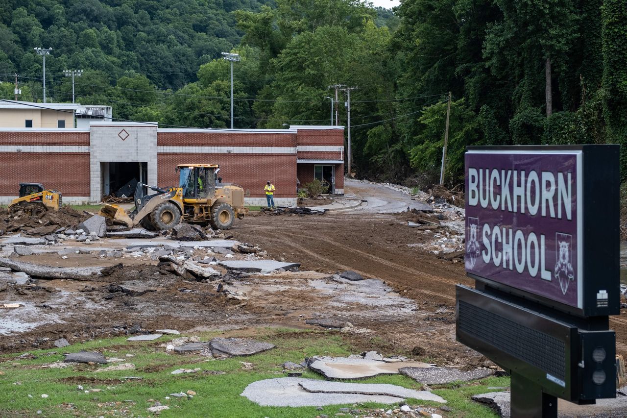 State workers remove debris from Buckhorn School in Buckhorn, Kentucky, following historic flooding in Eastern Kentucky on July 31. 