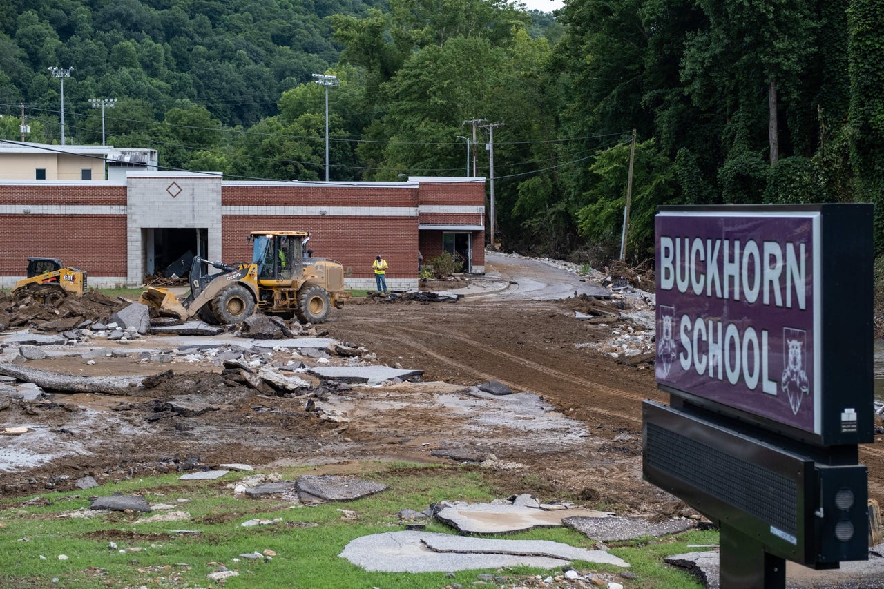 State workers remove debris from Buckhorn School in Buckhorn, Kentucky, following historic flooding in Eastern Kentucky on July 31. 