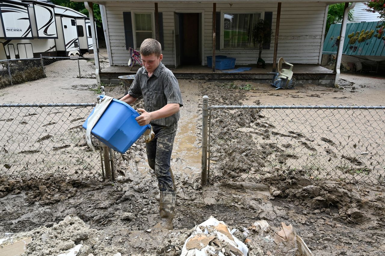 Members of the local Mennonite community remove mud-filled debris from homes following flooding at Ogden Hollar in Hindman, Kentucky, on July 30.