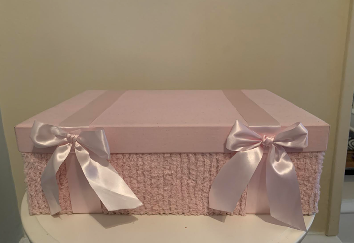 The pink box given to the author by her principal, Gaye. "I still use it to store mementos of Kathryn," she writes.