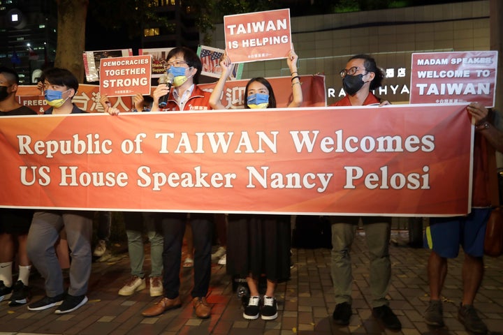 Supporters hold a banner outside the hotel where U.S. House Speaker Nancy Pelosi is supposed to be staying in Taipei, Taiwan, Tuesday, Aug 2, 2022.