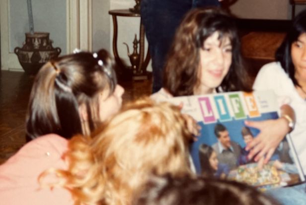 The author, age 13, with "The Game of Life" board game that Jeremy gave her.