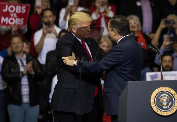 Then-President Donald Trump is brought onstage by Sen. Ted Cruz (R-TX) during a rally on Oct. 22, 2018, at the Toyota Center in Houston, Texas.