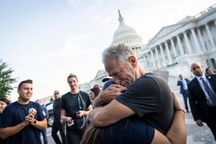 Jon Stewart hugs Rosie Torres, whose husband Le Roy suffers from illnesses related to his burn pit exposures in Iraq.