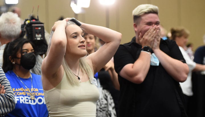 Pro-choice supporters Alie Utley and Joe Moyer (R) react to their county voting against the proposed constitutional amendment during the Kansas for Constitutional Freedom primary election watch party in Overland Park, Kansas, on Aug. 2.