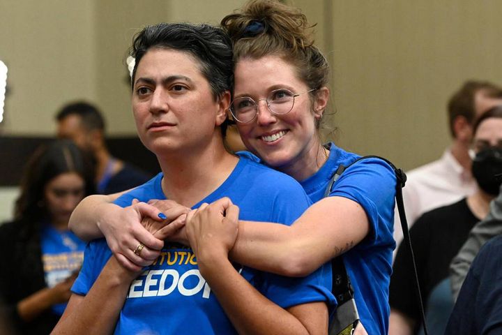 Dr. Iman Alsaden, abortion provider and chief medical officer for Planned Parenthood Great Plains, and Kelsey Rhodes of Kansas City hug as they and Kansans for Constitutional Freedom supporters celebrate a victory at the polls on Tuesday night.