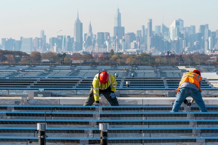 Union electricians install solar panels on top of the Terminal B garage at LaGuardia Airport in November 2021. (AP Photo/Mary Altaffer, File)