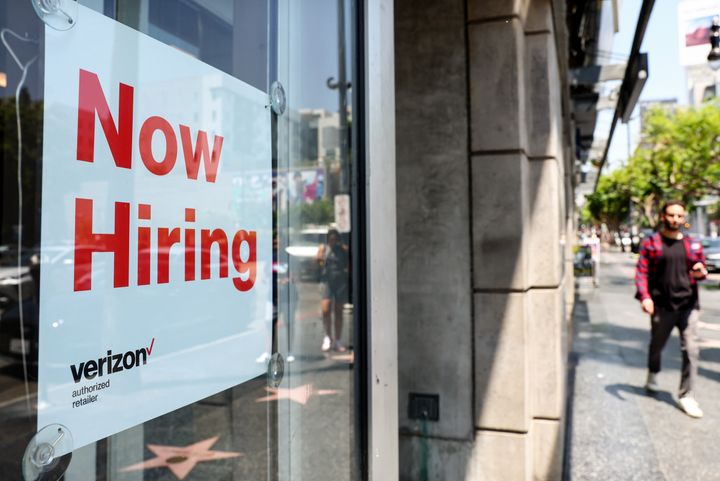 A 'Now Hiring' sign is posted at a Verizon store on July 26, 2022 in Los Angeles, California. As the Federal Reserve continues to increase interest rates, the labor market is starting to show signs of slowing down.