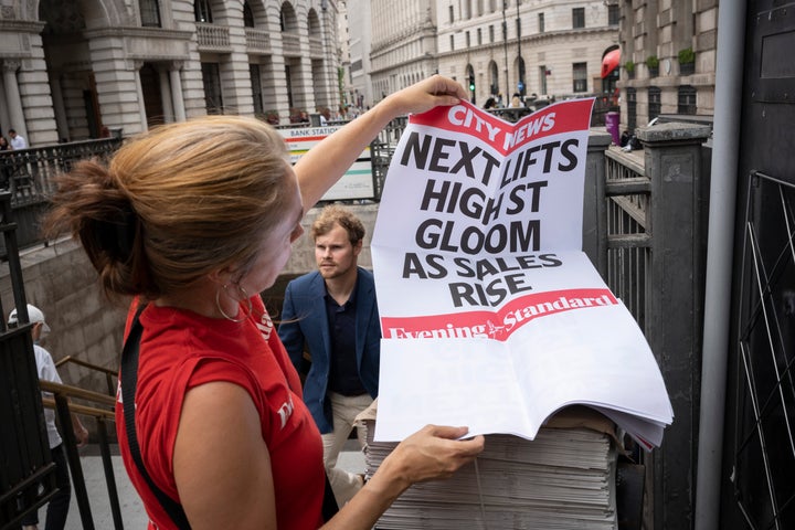 On the day that the Bank of England announced a rise, from 1.25% to 1.75% in the interest rate, the highest increase in 27 years, an Evening Standard vendor unfolds the latest news headline banner sheets which refer to high street economic gloom, on 4th August 2022, in the City of London, England. This increase is widely seen as a slide towards inflation with a shrinking of the UK economy - the start of its fall into recession in the third financial quarter of 2022. (Photo by Richard Baker / In Pictures via Getty Images)