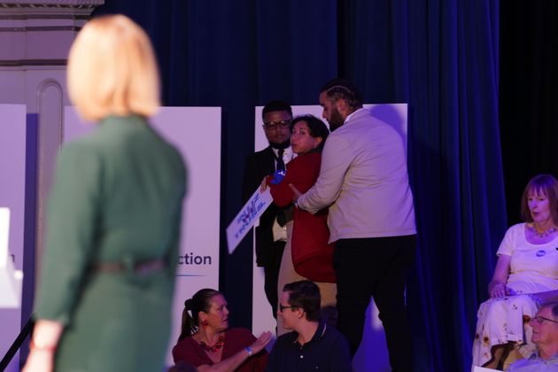 A protester interrupts Liz Truss's speech during a hustings event in Eastbourne, as part of the campaign to be leader of the Conservative Party and the next prime minister.