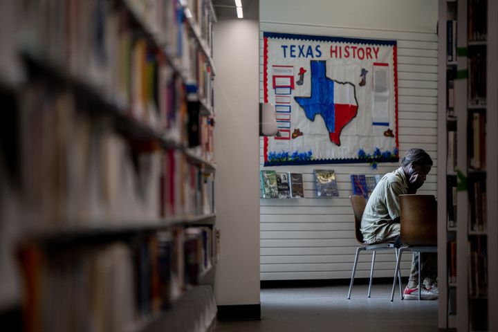 A person sits at the Houston Public Library on April 26, 2022 in Houston, Texas.  A group of local residents is suing Llano County in federal court for the removal of the county and censorship of library books dealing with racism and LGBT issues.