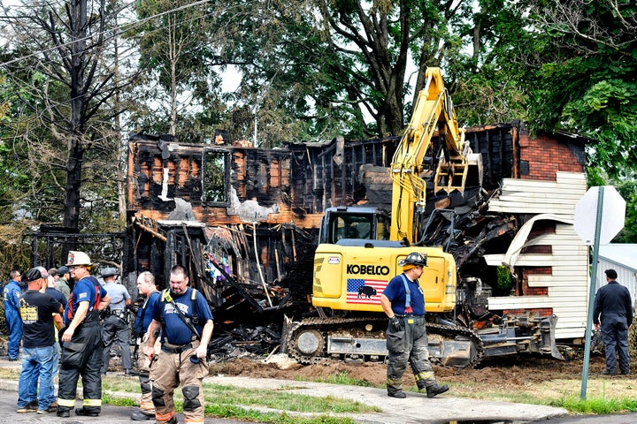 Crews work to demolish the house destroyed by a fatal fire in Nescopeck, Pennsylvania on Friday.