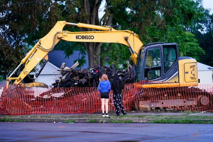 Young people visit the site of the fatal fire in northeastern Pennsylvania on Friday. A criminal investigation is underway, police said.