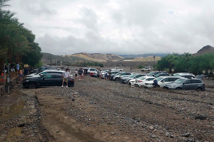 In this photo provided by the National Park Service, cars are stuck in mud and debris from flash flooding at The Inn at Death Valley in Death Valley National Park, Calif., Friday, Aug. 5, 2022.