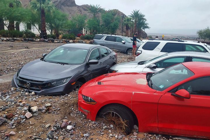In this photo provided by the National Park Service, cars are stuck in mud and debris from flash flooding at The Inn at Death Valley in Death Valley National Park, Calif., Friday, Aug. 5, 2022. Heavy rains have triggered flash flooding that closed several roads in Death Valley National Park on Friday near the California-Nevada line. 