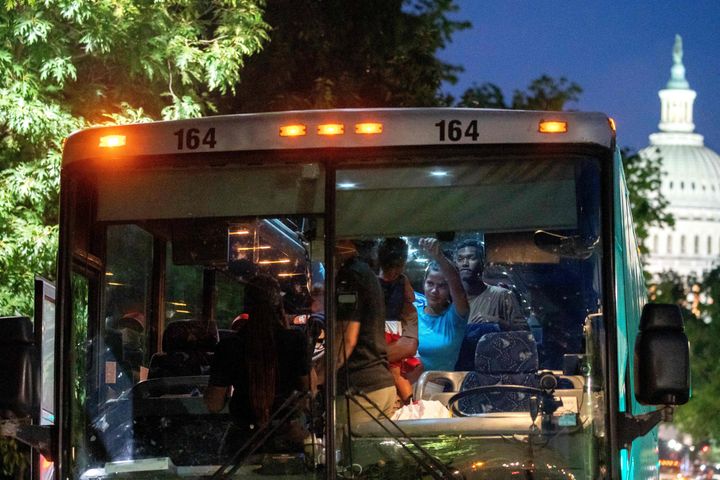 Migrants from Venezuela, who boarded a bus in Del Rio, Texas, disembark within view of the U.S. Capitol on Aug. 2. Since April, Texas Gov. Greg Abbott (R) has ordered over 150 buses to carry approximately 4,500 migrants from Texas.