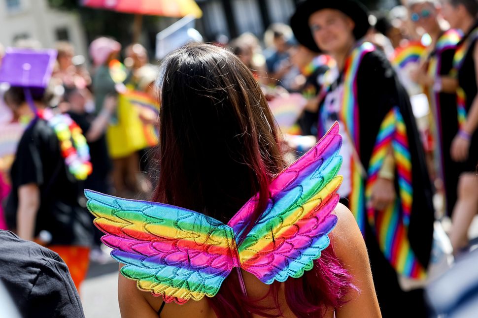BRIGHTON, ENGLAND - AUGUST 06: A festival goer wears rainbow coloured wings as they participate in the Pride LGBTQ+ Community Parade – ‘Love, Protest & Unity’ during the Brighton Pride on August 06, 2022 in Brighton, England. (Photo by Tristan Fewings/Getty Images)