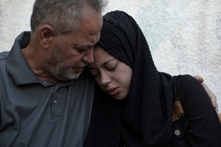 Relatives of Ismail Dweik, who was killed in an Israeli airstrike, mourn before his funeral, outside a hospital in Rafah, in the southern Gaza Strip, on Aug. 7, 2022.