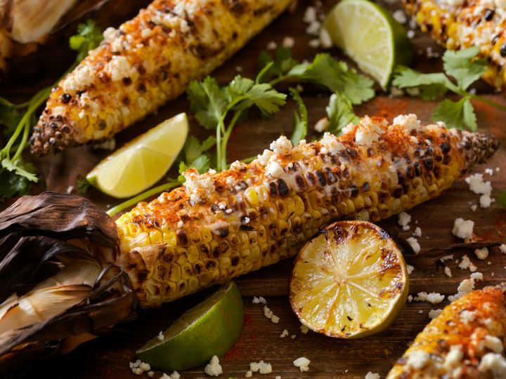 Mexican style street corn, or elote, is topped with a mayo or sour cream sauce, cotjia cheese, chili powder and fresh cilantro. 
