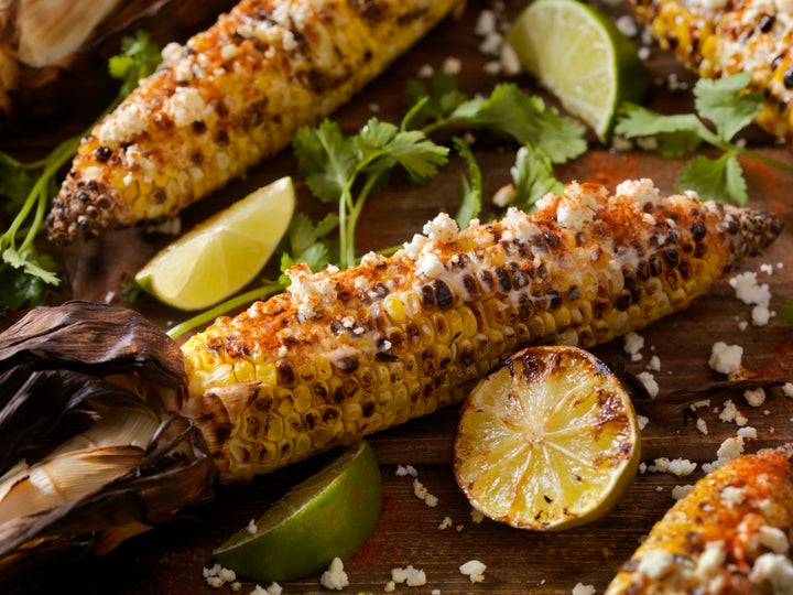 Mexican style street corn, or elote, is topped with a mayo or sour cream sauce, cotjia cheese, chili powder and fresh cilantro. 