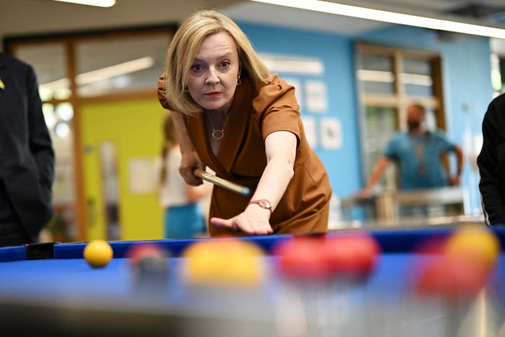 Liz Truss plays pool during a visit to Chelmsford.