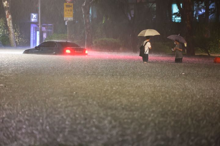 A vehicle is submerged in a flooded road in Seoul, on Aug. 8, 2022. Heavy rains drenched South Korea's capital region, turning the streets of Seoul's affluent Gangnam district into a river, leaving submerged vehicles and overwhelming public transport systems.