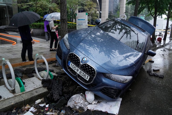 A vehicle sits damaged on a road after floating in heavy rainfall in Seoul, South Korea, Tuesday, Aug. 9, 2022. Heavy rains drenched South Korea's capital region, turning the streets of Seoul's affluent Gangnam district into a river, leaving submerged vehicles and overwhelming public transport systems.