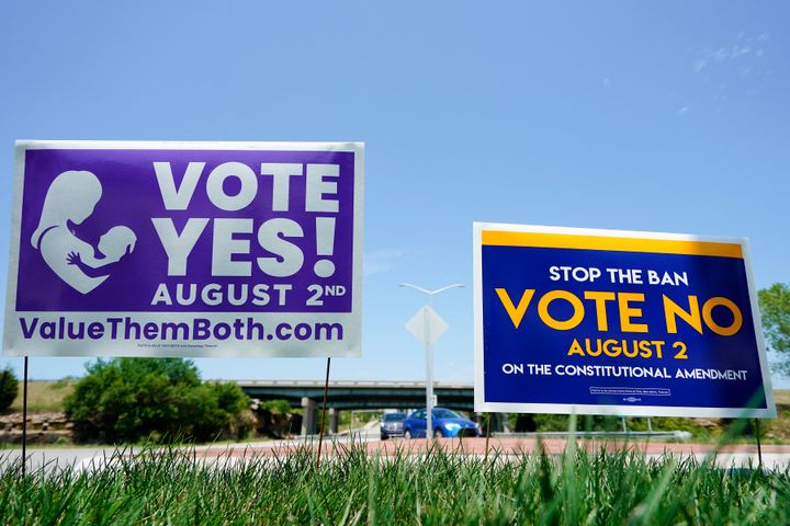 Signs in favor and against the Kansas constitutional amendment on abortion are displayed outside Kansas 10 Highway on Aug. 1, 2022, in Lenexa, Kansas.