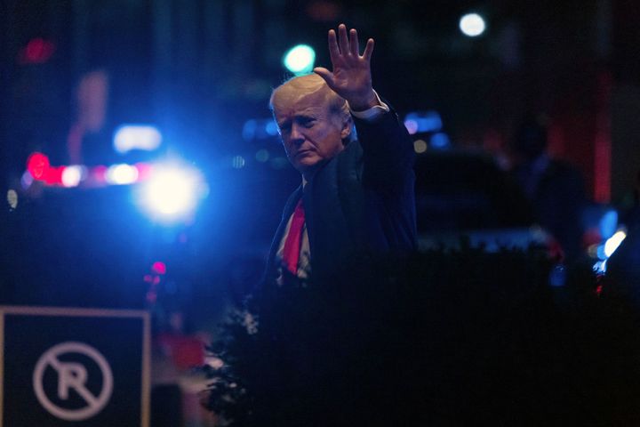 Former President Donald Trump walks into New York's Trump Tower late Tuesday night.