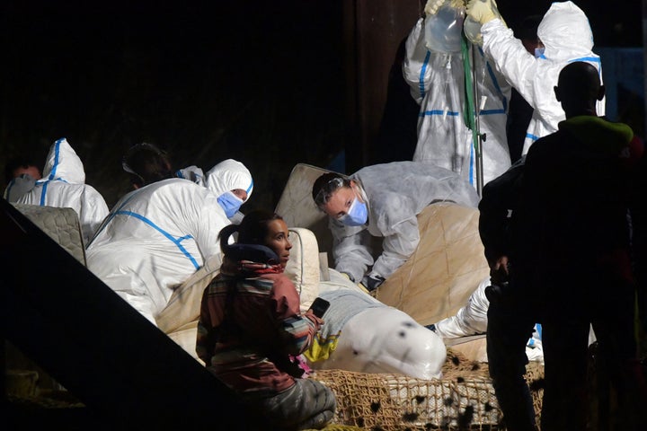 Veterinarians take care of a beluga whale that was stranded in the River Seine at Notre Dame de la-Garenne, northern France, on Aug. 9, 2022. French marine experts launched an ambitious operation to return the whale to the sea.