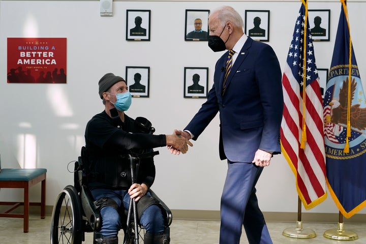 President Joe Biden shakes hands with veteran John Caruso as Biden tour's the Fort Worth VA Clinic in Fort Worth, Texas, on March 8, 2022. Biden will sign veterans health care legislation on Aug. 10, that ends a long battle to expand benefits for people who served near burn pits. It's a personal issue for Biden. His son Beau was a major in the Delaware Army National Guard, and he died of cancer after his service in Iraq.