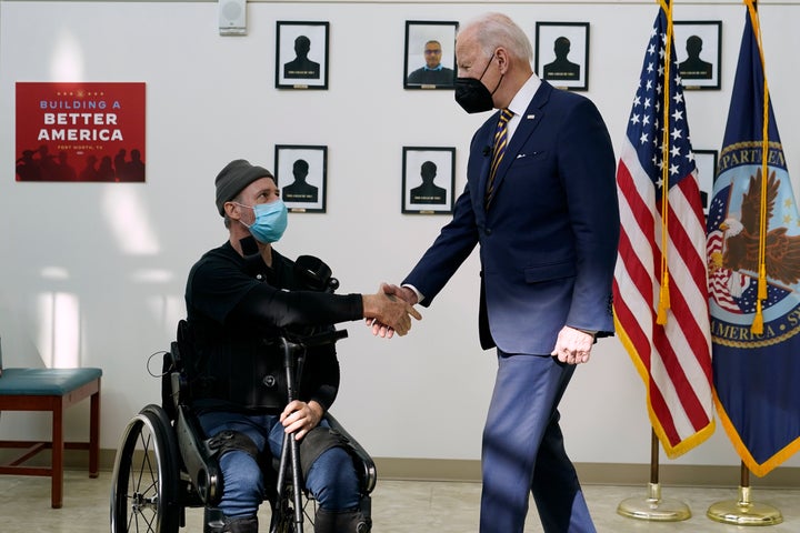 President Joe Biden shakes hands with veteran John Caruso as Biden tour's the Fort Worth VA Clinic in Fort Worth, Texas, on March 8, 2022. Biden will sign veterans health care legislation on Aug. 10, that ends a long battle to expand benefits for people who served near burn pits. It's a personal issue for Biden. His son Beau was a major in the Delaware Army National Guard, and he died of cancer after his service in Iraq. 