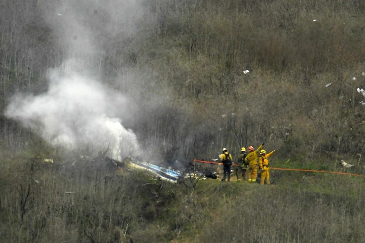 Firefighters work the scene of a helicopter crash where former NBA basketball star Kobe Bryant died in Calabasas, Calif., Jan. 26, 2020. 