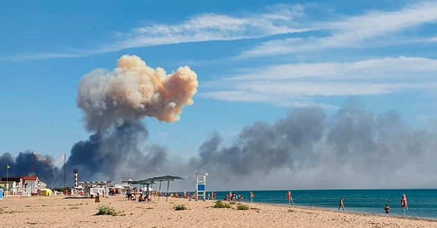 Rising smoke can be seen from the beach at Saki after explosions were heard from the direction of a Russian military airbase near Novofedorivka, Crimea.