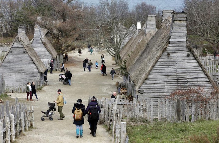 Visitors walk through the 17th-century English village exhibit at the Plimoth Patuxet Museums on Nov. 18, 2018, in Plymouth, Mass.
