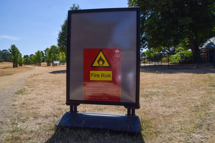  A fire risk sign is seen in a dry Richmond Park as heatwaves and drought conditions caused by climate change continue across the UK.