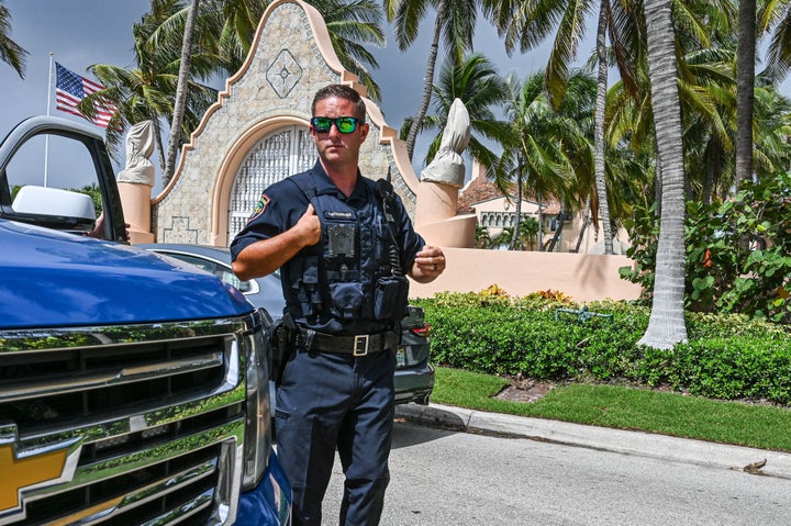 Local law enforcement officers stand guard in front of Trump's Mar-A-Lago property on Aug. 9.