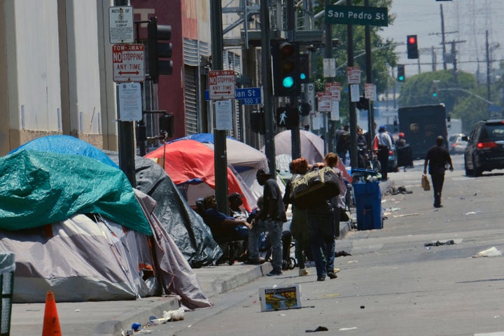 In this May 30, 2019, photo, tents housing homeless people line a street in downtown Los Angeles. The Los Angeles City Council voted Tuesday to broaden an existing ban on homeless encampments near schools and day care centers.