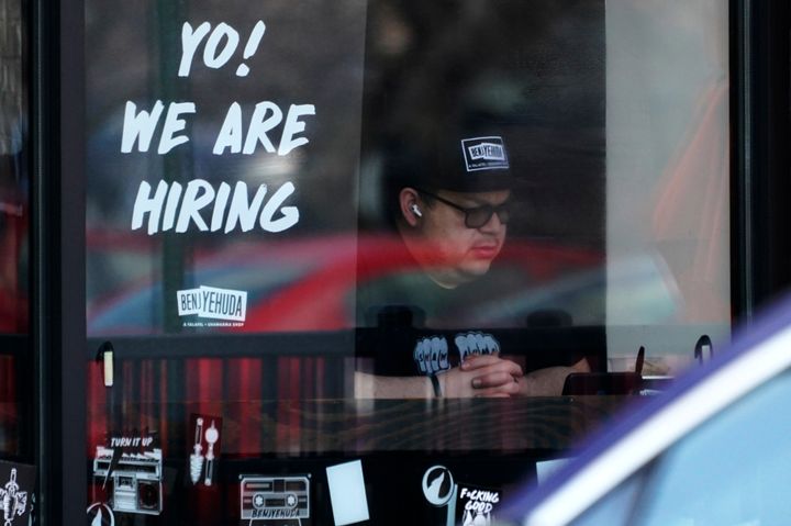 A hiring sign is displayed at a restaurant in Schaumburg, Ill., on April 1, 2022. More Americans applied for jobless benefits last week, reported Thursday, Aug. 4, 2022, as the number of unemployed continues to rise modestly, though the labor market remains one of the strongest parts of the U.S. economy.