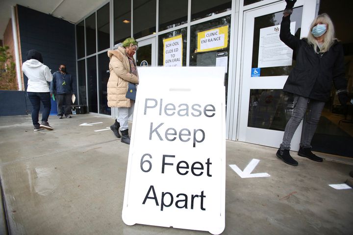 A sign asks those getting vaccinated to keep 6 feet apart during a vaccination event, Wednesday, Jan. 27, 2021, at Nevada Union High School in Grass Valley, Calif. (Elias Funez/The Union via AP, File)