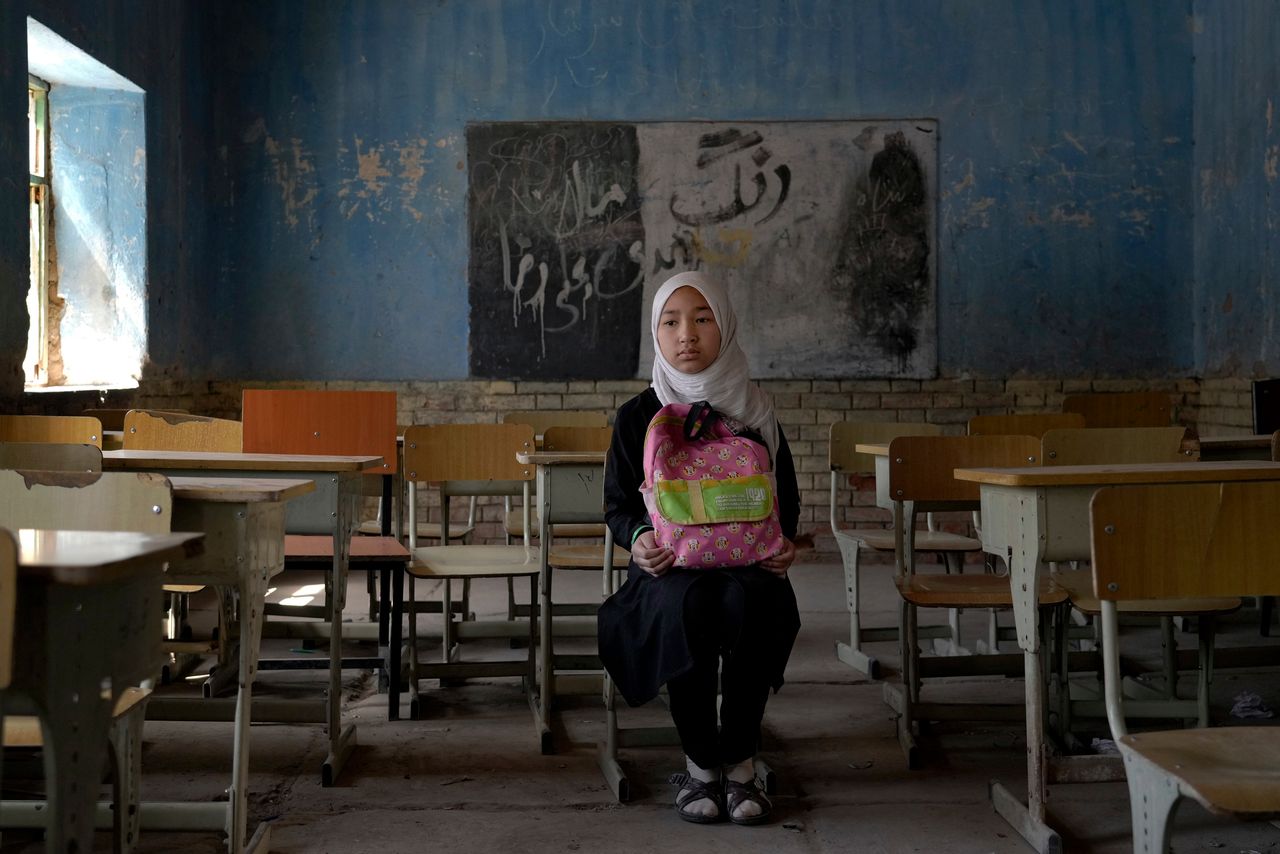 Fereshteh, 11, a Hazara Shiite student, poses for a photo in her classroom in Kabul, Afghanistan, on April 23, 2022. 