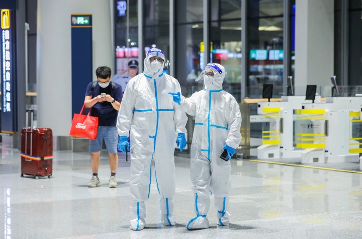 Sanitarios equipados con un traje protector en un aeropuerto de China.