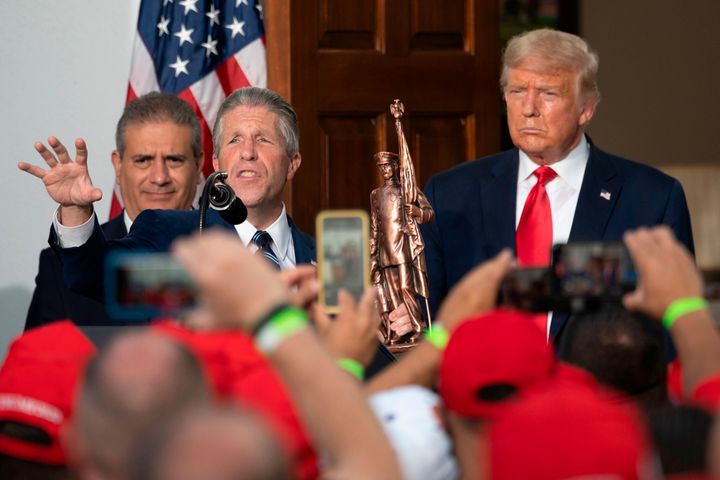 NYC PBA President Patrick Lynch (center) presents then-President Donald Trump with a statue on Aug. 14, 2020. The union's endorsement of Trump has elicited criticism.