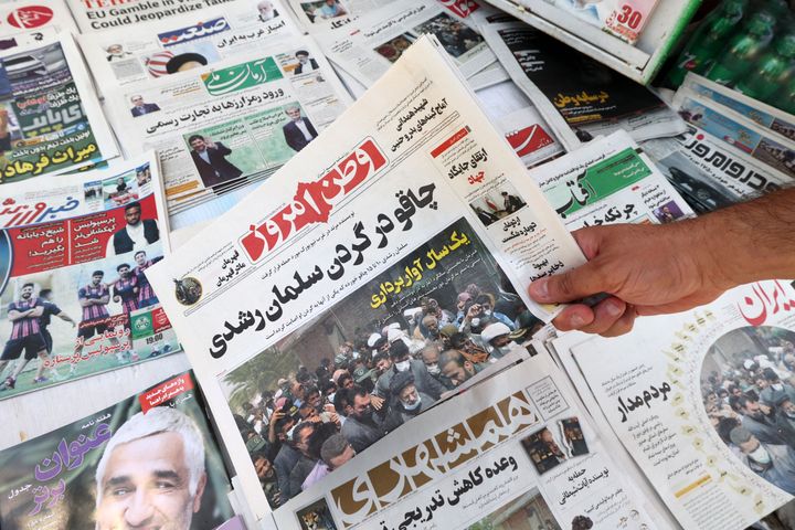 A man shows Iranian newspapers with a front page title reading in Farsi: "Knife in the neck of Salman Rushdie." Iranians reacted with praise and worry Saturday over the attack on the author, who has been the target of a decades-old fatwa by the late Supreme Leader Ayatollah Ruhollah Khomeini, the AP reported.
