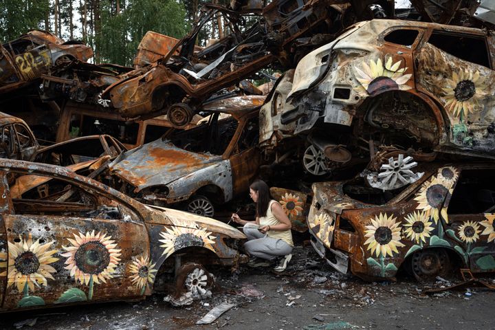Ukrainian artist Olena Yanko paints sunflowers on cars which were destroyed by Russian attacks in Irpin on the outskirts of Kyiv on Aug. 12. She came as a volunteer to paint cars, the destroyed Palace of Culture and school basements for the project "Flowers For Hope" which aims to provide a distraction in environments devastated by war and raise money for humanitarian aid. 